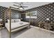 Stylish bedroom features a modern ceiling fan and designer wallpaper at 8707 E Clarendon Ave, Scottsdale, AZ 85251
