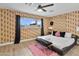 Stylish bedroom features hardwood floors, modern ceiling fan, natural light and unique animal print wallpaper at 8707 E Clarendon Ave, Scottsdale, AZ 85251