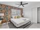 Cozy bedroom features a modern ceiling fan, natural light, and stylish floral wallpaper at 8707 E Clarendon Ave, Scottsdale, AZ 85251