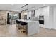 Open kitchen area with an island, marble countertop, pendant lights, and decorative wall accents at 8707 E Clarendon Ave, Scottsdale, AZ 85251