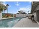 Backyard featuring a pool, a mural on the privacy wall, and outdoor seating and grill at 8707 E Clarendon Ave, Scottsdale, AZ 85251