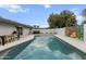 Inviting backyard featuring a pool, a hot tub, outdoor seating, privacy walls, and grill at 8707 E Clarendon Ave, Scottsdale, AZ 85251
