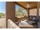 Outdoor balcony with seating and a ceiling fan, overlooking desert landscaping at 8880 E Paraiso Dr # 118, Scottsdale, AZ 85255