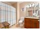 Well-lit bathroom features a shower/tub combo and a vanity with ample storage at 8880 E Paraiso Dr # 118, Scottsdale, AZ 85255