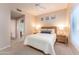 Comfortable bedroom with neutral decor, natural light and ceiling fan at 8880 E Paraiso Dr # 118, Scottsdale, AZ 85255