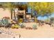 Beautiful condo with desert landscaping, mature trees, and a decorative Mirage Village sign at 8880 E Paraiso Dr # 118, Scottsdale, AZ 85255