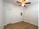 Bright bedroom featuring wood-look flooring, a ceiling fan, and ample closet space at 1219 E Colter St # 8, Phoenix, AZ 85014