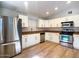 Bright kitchen features stainless appliances, wood-look floors and white cabinets at 1219 E Colter St # 8, Phoenix, AZ 85014
