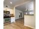 Modern kitchen featuring stainless steel appliances and an open layout with warm, wood-look flooring at 1219 E Colter St # 8, Phoenix, AZ 85014