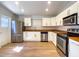 Bright kitchen features stainless appliances, wood-look floors and white cabinets at 1219 E Colter St # 8, Phoenix, AZ 85014