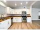 Bright kitchen features stainless appliances, wood-look floors and white cabinets at 1219 E Colter St # 8, Phoenix, AZ 85014