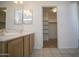 Bathroom with walk-in closet and dual sink vanity at 12205 N 41St Ln, Phoenix, AZ 85029