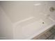 Clean, white bathtub with tile surround at 12205 N 41St Ln, Phoenix, AZ 85029