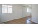 Clean bedroom featuring wood-look floors, large mirrored closet, and natural light at 12205 N 41St Ln, Phoenix, AZ 85029