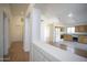 Open-concept hallway with wood floors leading to kitchen featuring updated cabinets and appliances at 12205 N 41St Ln, Phoenix, AZ 85029
