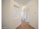 Bright hallway featuring wood floors, white walls, and a cutout detail at 12205 N 41St Ln, Phoenix, AZ 85029