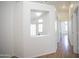 Hallway showing view into room with lots of natural light and neutral paint at 12205 N 41St Ln, Phoenix, AZ 85029