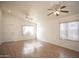 Bright and airy living room with wood floors, ceiling fans, and a large window at 12205 N 41St Ln, Phoenix, AZ 85029