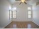 Cozy living room with a ceiling fan, wood floors, and windows for abundant natural light at 12205 N 41St Ln, Phoenix, AZ 85029