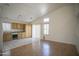 Bright living space with an adjacent eat-in kitchen with tile flooring and cabinetry at 12205 N 41St Ln, Phoenix, AZ 85029