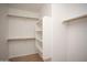 Spacious walk-in closet featuring multiple shelves and wooden rods for efficient storage at 12205 N 41St Ln, Phoenix, AZ 85029
