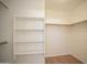 Bright walk-in closet with built-in shelving and wooden rods, offers ample storage space at 12205 N 41St Ln, Phoenix, AZ 85029
