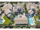 Aerial view of a home with a well-maintained lawn, patio, pool, and a spa surrounded by lush landscaping at 1379 S Claiborne Ave, Gilbert, AZ 85296