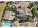 Aerial view of a backyard with a pool, outdoor seating, mature trees and landscaping, and a large patio at 1379 S Claiborne Ave, Gilbert, AZ 85296