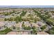 Aerial view of a community with mature trees, lush landscaping, and various house styles and colors at 1379 S Claiborne Ave, Gilbert, AZ 85296