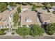 Aerial view of a home showing a tile roof, backyard pool and spa, and a three car garage at 1379 S Claiborne Ave, Gilbert, AZ 85296