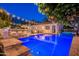 Lovely backyard featuring a refreshing pool and hot tub, bar with seating and outdoor lounge chairs at 1379 S Claiborne Ave, Gilbert, AZ 85296