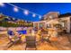 Cozy backyard with outdoor seating around the fire pit, a sparkling pool, and a bar for entertaining at 1379 S Claiborne Ave, Gilbert, AZ 85296