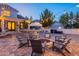 Spacious backyard with an outdoor kitchen and a cozy fire pit surrounded by comfortable seating at 1379 S Claiborne Ave, Gilbert, AZ 85296