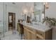 Bathroom featuring a shared vanity area with framed mirrors, modern lighting, and marble-look hexagonal floors at 1379 S Claiborne Ave, Gilbert, AZ 85296