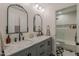 Modern bathroom with dual sinks, marble countertops, and a glass-enclosed shower providing a spa-like experience at 1379 S Claiborne Ave, Gilbert, AZ 85296