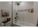 Modern bathroom boasts white tile, a glass shower door, and sleek fixtures for a clean, spa-like feel at 1379 S Claiborne Ave, Gilbert, AZ 85296