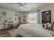 Bright bedroom with a cozy seating area, decorative artwork, and a large window overlooking the yard at 1379 S Claiborne Ave, Gilbert, AZ 85296
