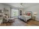 Inviting bedroom featuring a cozy armchair, ottoman, large window, and ample natural light at 1379 S Claiborne Ave, Gilbert, AZ 85296