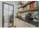 Stylish butler's pantry featuring dark countertops, cabinetry, shelves, wine rack, and decorative display items at 1379 S Claiborne Ave, Gilbert, AZ 85296