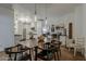 Open dining room adjacent to kitchen features modern light fixtures, table, and seating at 1379 S Claiborne Ave, Gilbert, AZ 85296