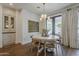 Well-lit dining area featuring a round table, modern chandelier, and french doors that lead to an outdoor patio at 1379 S Claiborne Ave, Gilbert, AZ 85296