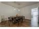 Dining room with hardwood floors, pendant lights and view to the living room at 1379 S Claiborne Ave, Gilbert, AZ 85296