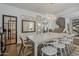 Bright dining room featuring a long table, modern chandelier, and staircase to the second floor at 1379 S Claiborne Ave, Gilbert, AZ 85296