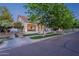 Attractive two-story home featuring a welcoming front porch, mature trees, and classic curb appeal at 1379 S Claiborne Ave, Gilbert, AZ 85296