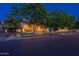 Charming home with well-manicured front yard and inviting front porch, surrounded by mature trees at 1379 S Claiborne Ave, Gilbert, AZ 85296