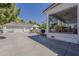 Exterior view of a home featuring a covered patio, large driveway, and a spacious backyard at 1379 S Claiborne Ave, Gilbert, AZ 85296