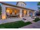 Home exterior featuring a charming front porch with brick accents, ample seating, and well-maintained landscaping at 1379 S Claiborne Ave, Gilbert, AZ 85296