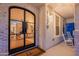 Stylish front door with glass panels, showcasing the interior living space and hardwood floors at 1379 S Claiborne Ave, Gilbert, AZ 85296