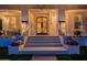 Inviting front entrance with decorative columns, accent lighting, and flower planters at 1379 S Claiborne Ave, Gilbert, AZ 85296
