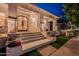 Charming home exterior with a welcoming front porch, featuring stylish front door, potted flowers, and manicured lawn at 1379 S Claiborne Ave, Gilbert, AZ 85296